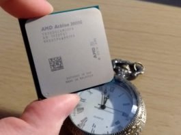 An amd athlon 3000g overclock - literally held above a clock.
