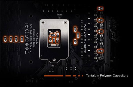 The tantalum polymer capacitors on a GIGABYTE Z490 AORUS XTREME. There's one for each DIMM slot, five behind the socket, three between the socket and VRM, and four amongst the VRM.
